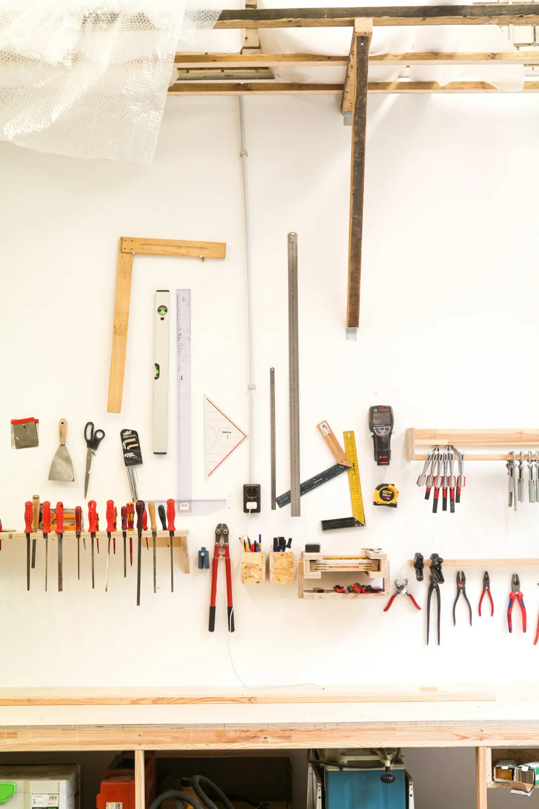 Hand tools arranged on a workshop wall